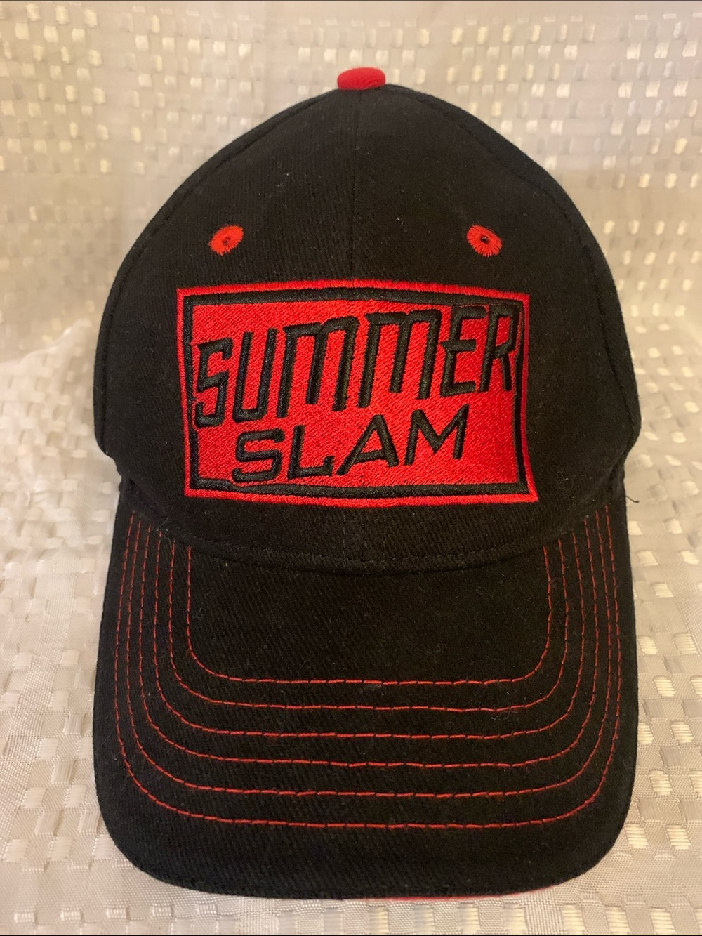 WWE black cap with “Summer Slam” embroidered in red on the front. Adjustable.
